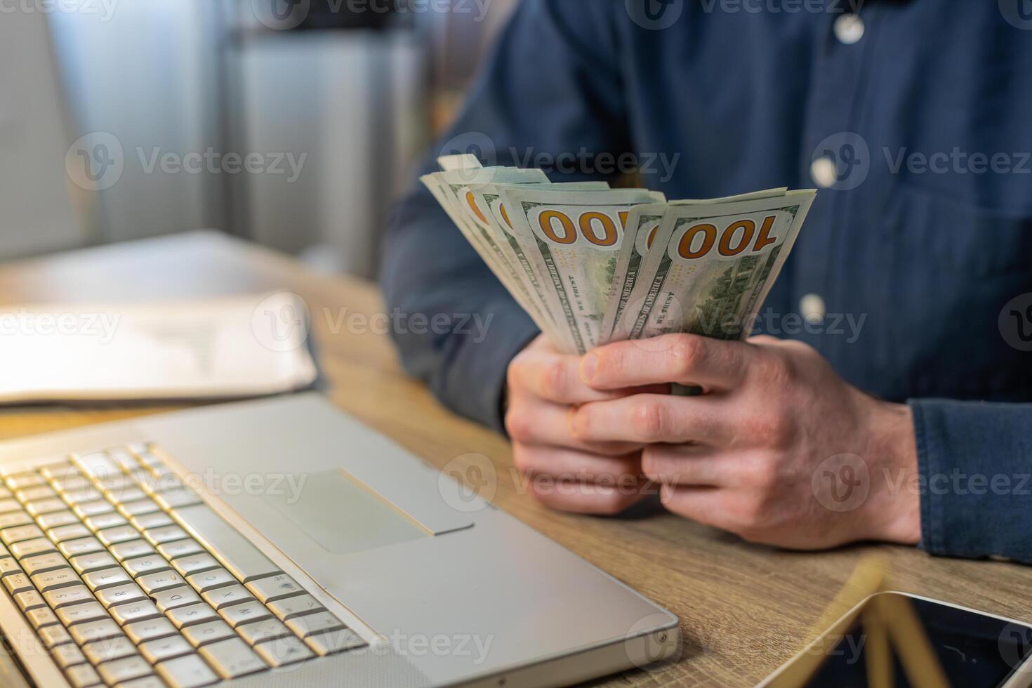 Close-up hands of businessman counting cash money dollar checking salary enjoy richness at workplace photo
