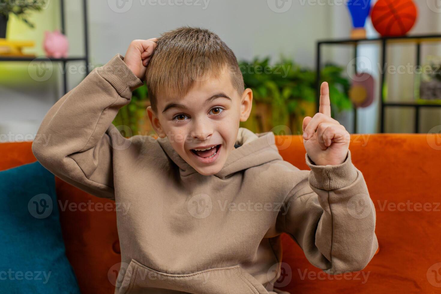 Thoughtful inspired child boy kid make Eureka gesture raises finger came up with creative plan photo