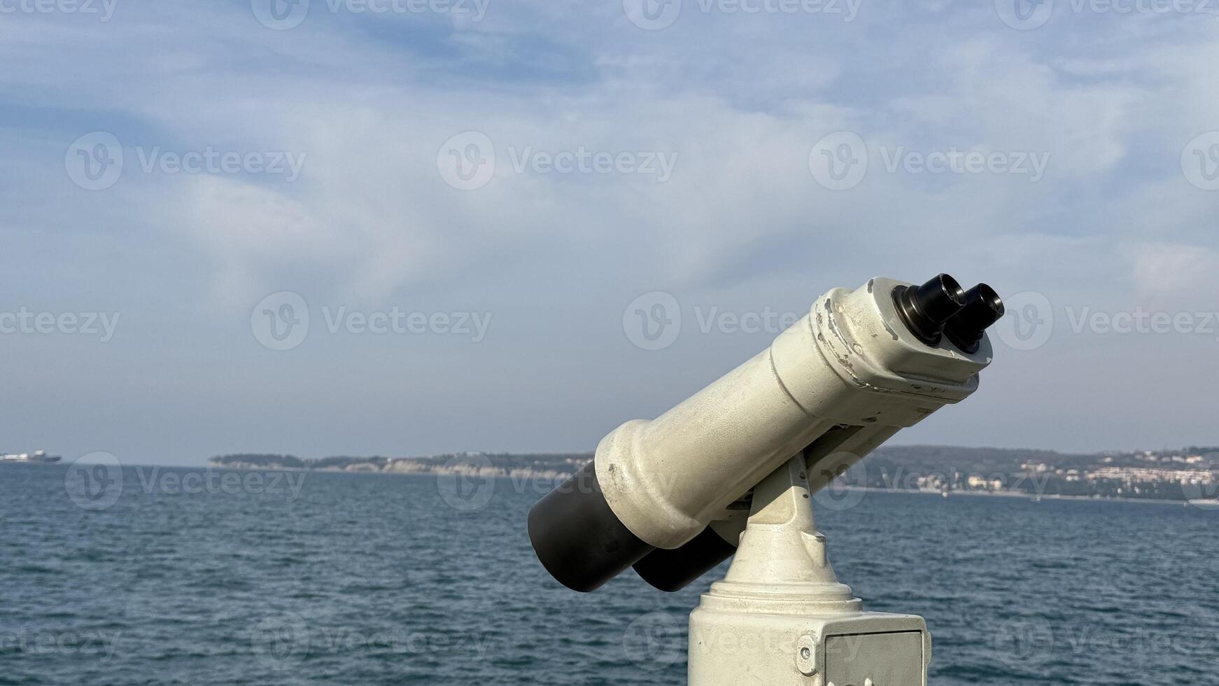 Seaside binoculars overlooking tranquil ocean, perfect for coastal exploration, summer vacation, maritime adventures, horizon view travel inspiration photo