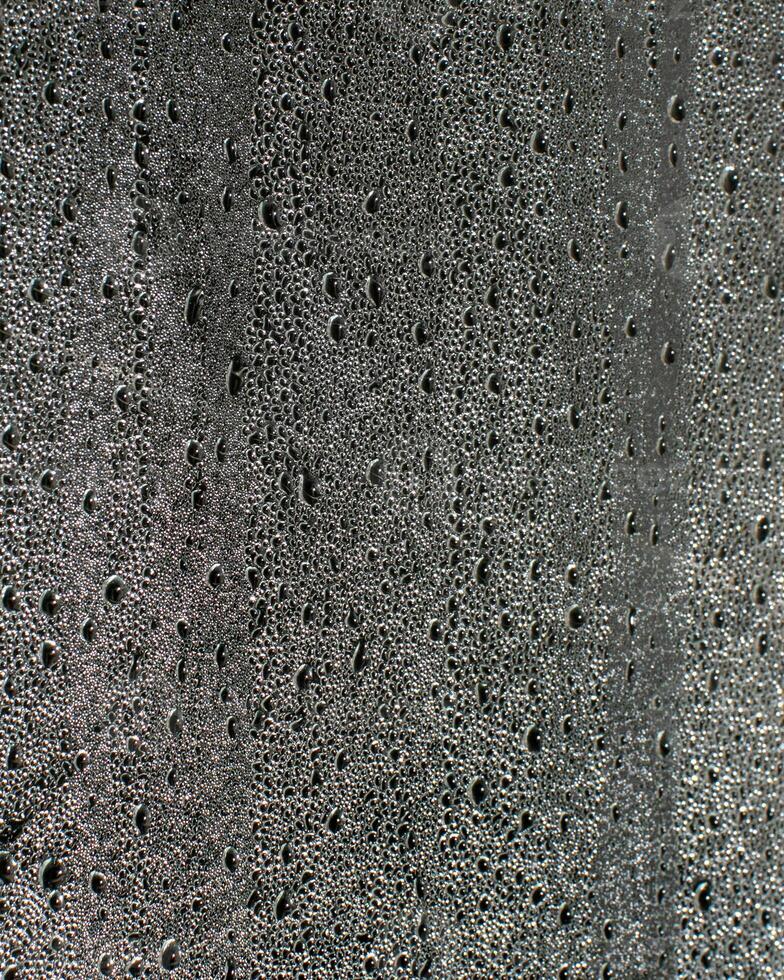 Wet concrete surface with raindrops texture, reflecting rainy season ambiance, suitable for construction projects and urban design inspiration photo
