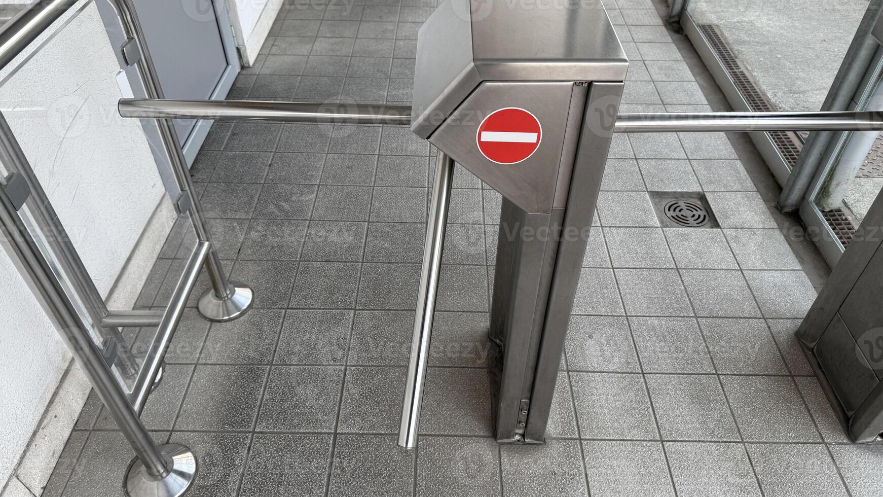 Sleek turnstile gate in modern office building, symbolizing security and access control, relevant for corporate environments and events photo