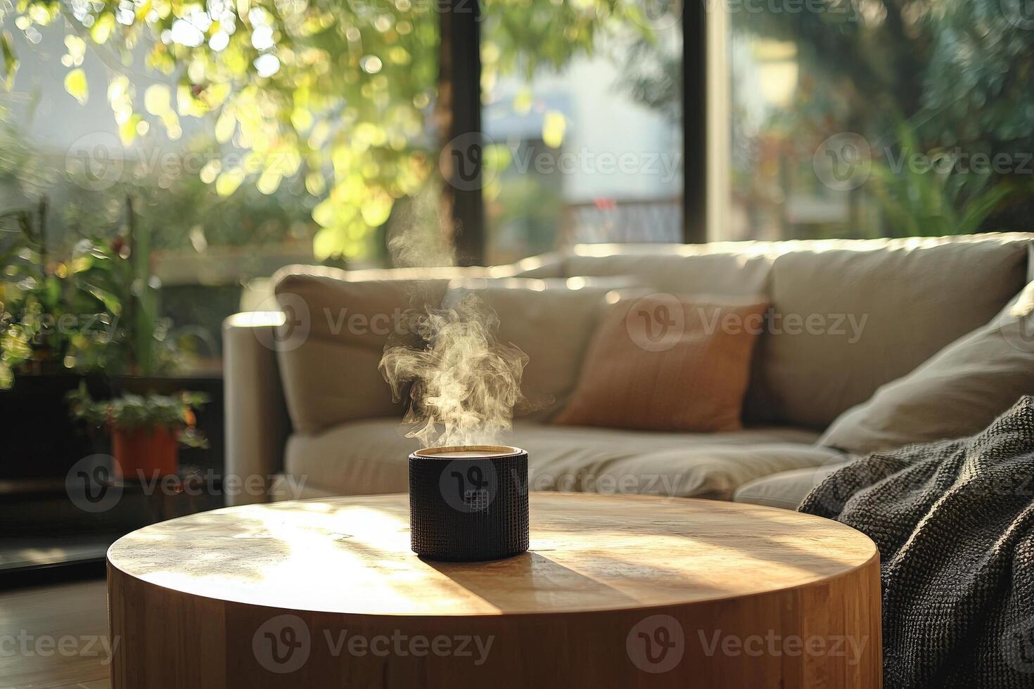 A steaming cup sits on a wooden table in a sunlit living room. The space features a comfortable sofa and plants, creating a peaceful and inviting atmosphere perfect for relaxation. photo