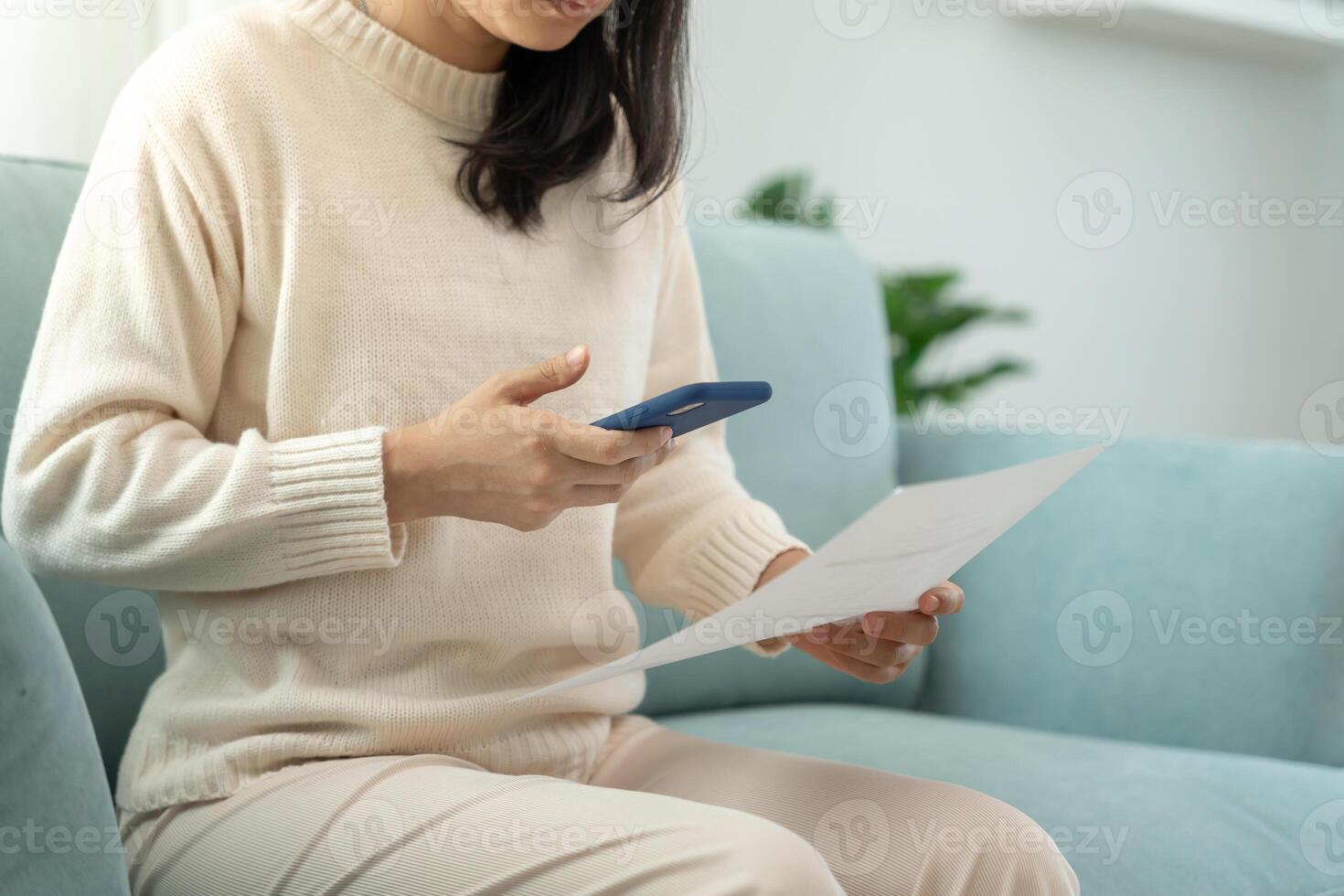 woman use phone scan barcode or QR codes to pay credit card bill after receiving document invoice. payment, receive, paying electricity, digital payments, technology, scanning, financial transactions. photo