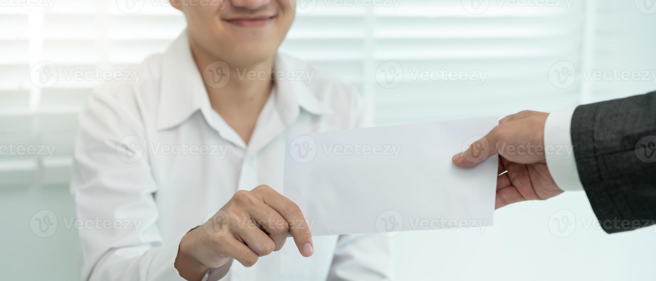 Business men receive salary or bonuses from management or Boss. Company give rewards to encourage work. Smiling businessman enjoying a reward at the desk in the office photo