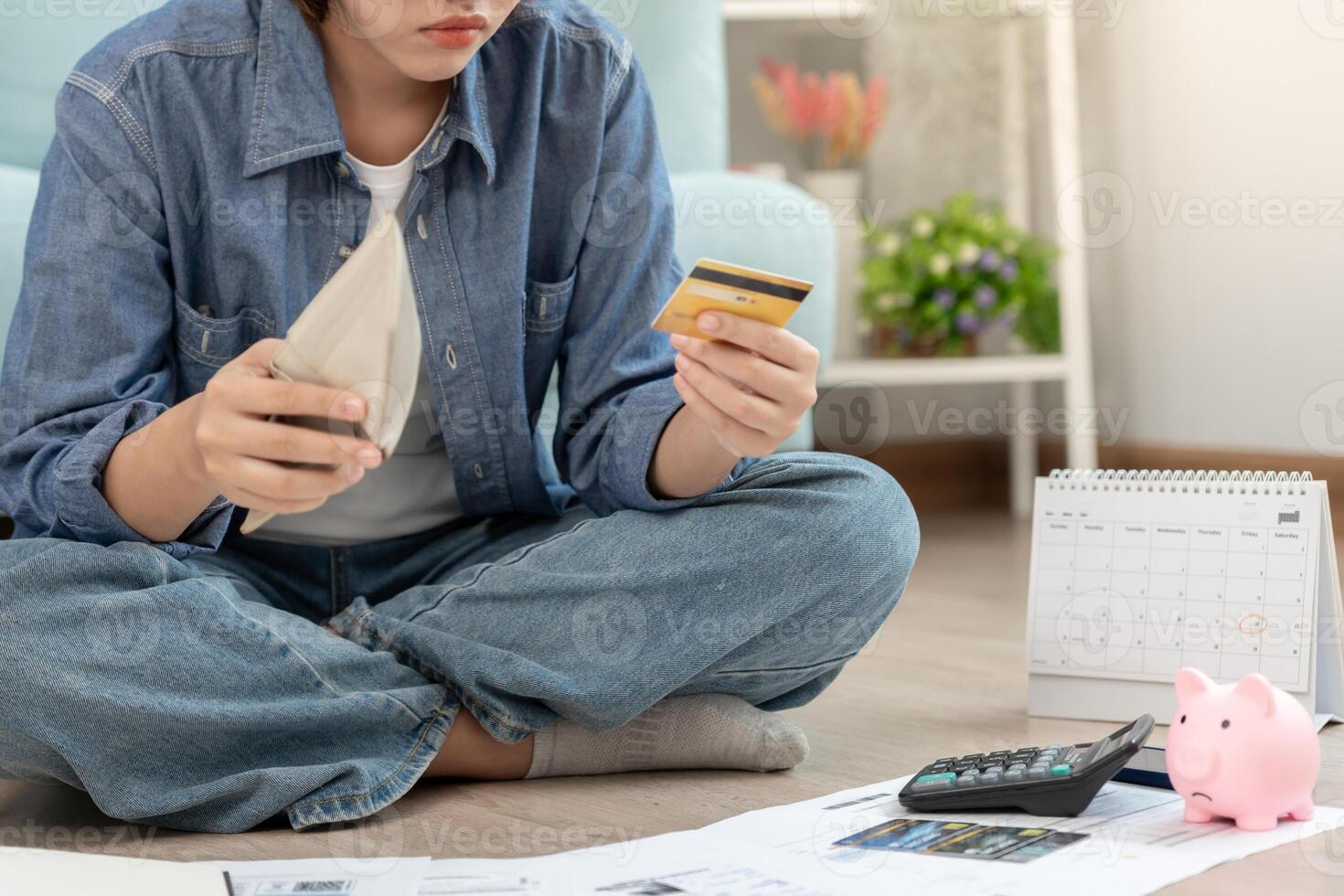 headache asian woman with large bills or invoices no money to pay to expenses and credit card debt. shortage, Financial problems, mortgage, loan, bankruptcy, bankrupt, poor, empty wallet. photo
