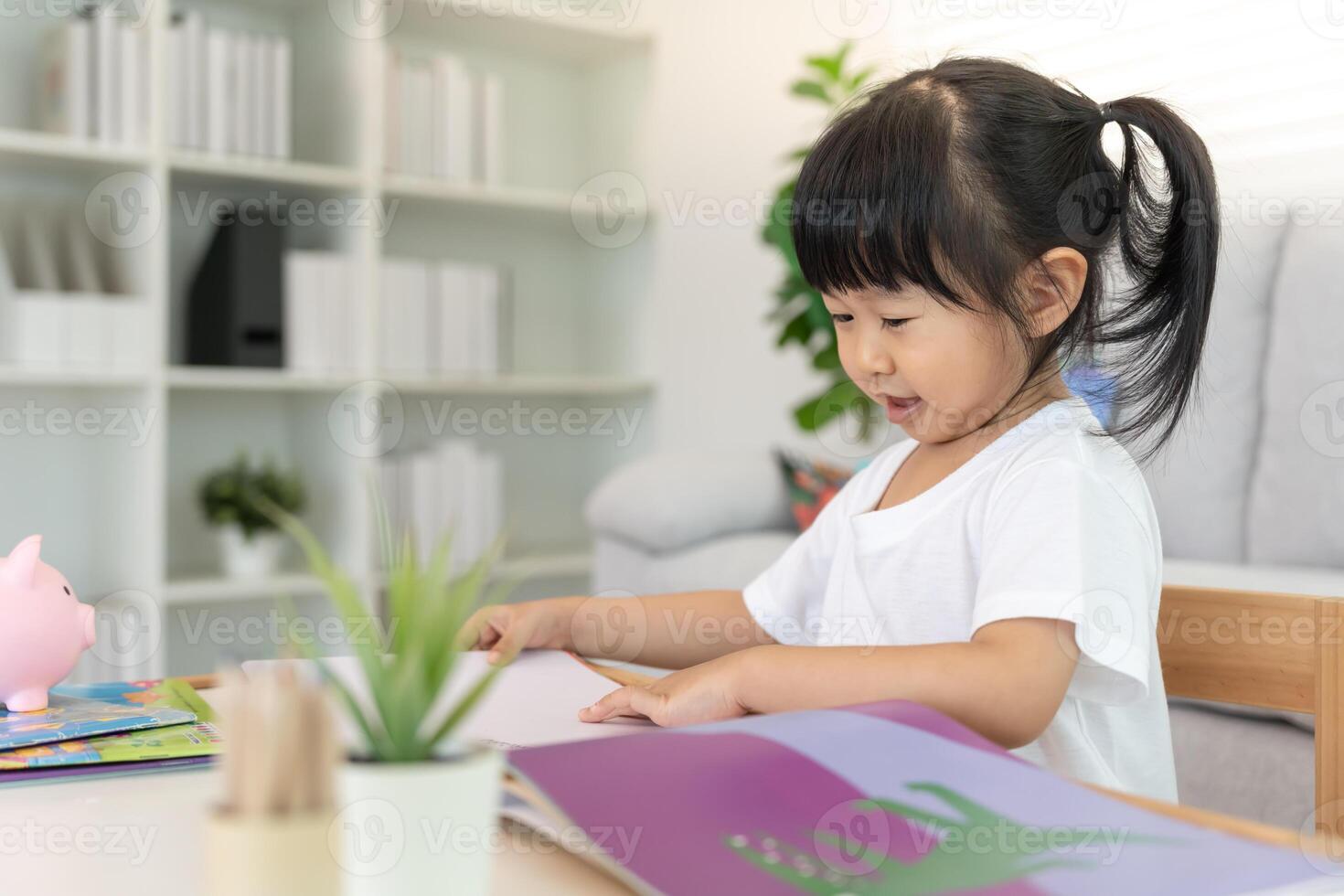 Happy Asian children relax read book at home. daughter and reading a story. learn development, childcare, laughing, education, storytelling, practice, imagine, reduce addiction. photo
