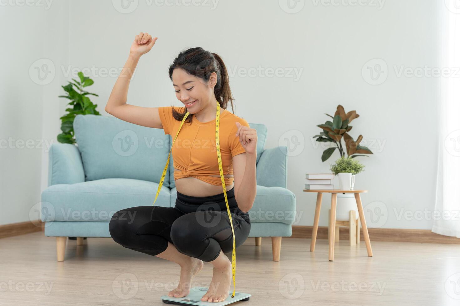 asian female happy results of diet. Beautiful shape. female have a reduced waist size after under going a weight loss corse. can not wear jean due to weight loss. balance, control, routines, exercise. photo