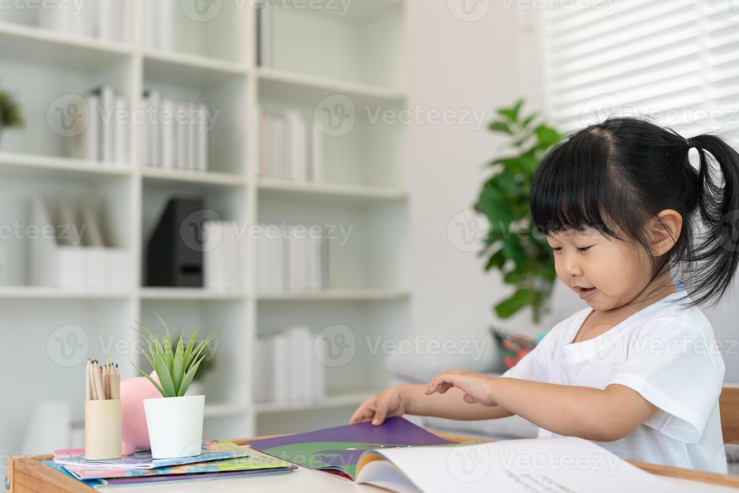Happy Asian girl relax read book at home. daughter and reading a story. learn development, childcare, laughing, education, storytelling, practice, imagine, reduce addiction mobile phone photo