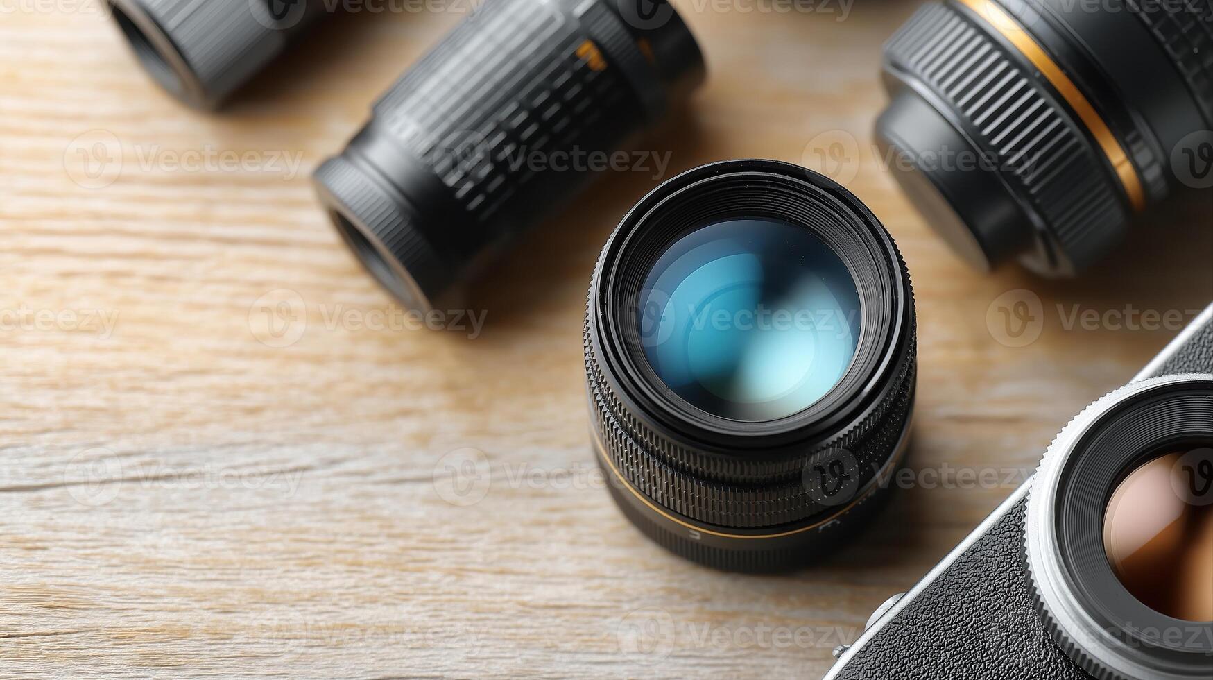 Close-Up View of Various Camera Lenses and a Camera Body on Wooden Table Surface photo