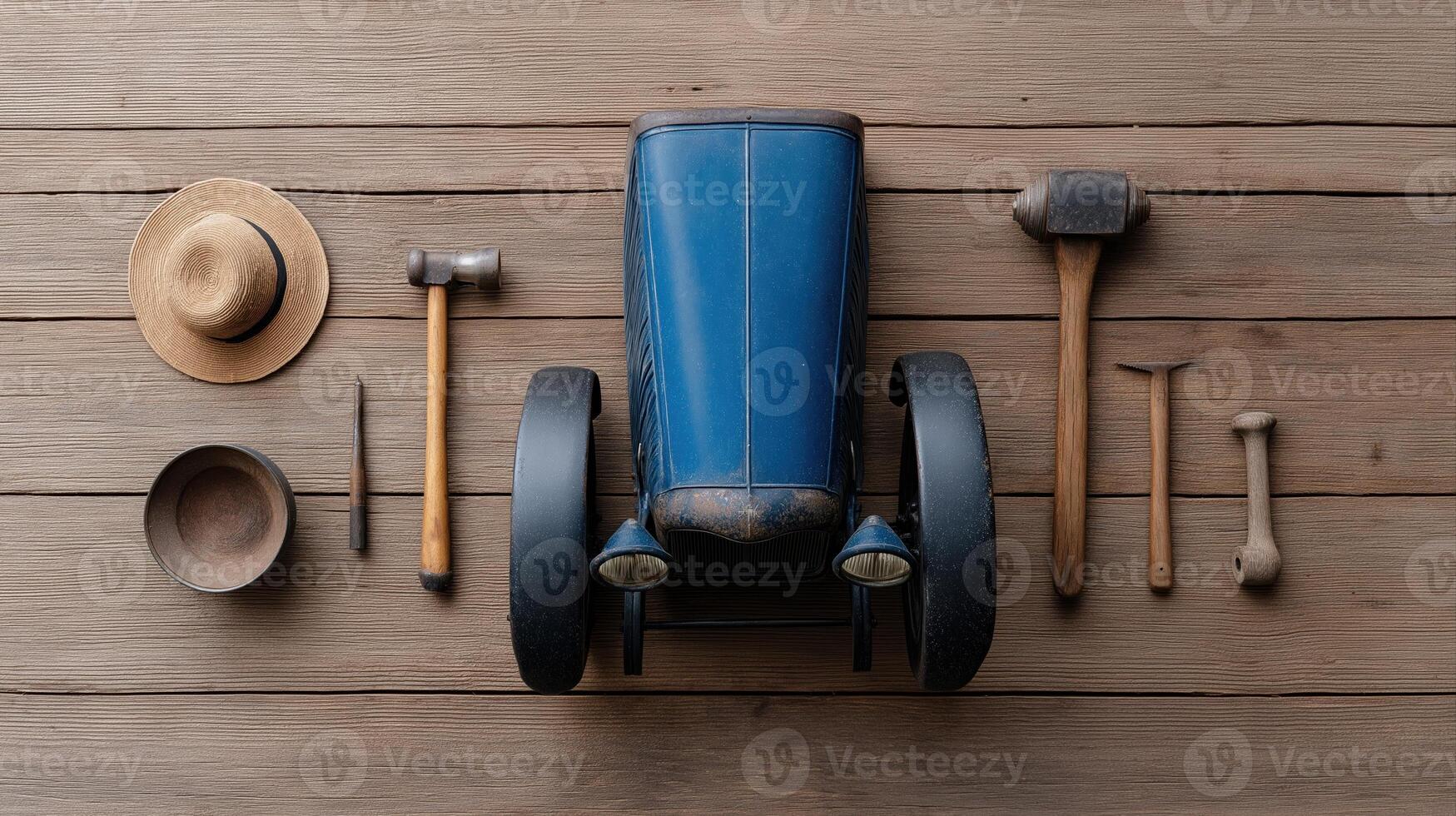 Vintage toy car with wooden tools and accessories on a rustic wooden background for creative designs photo