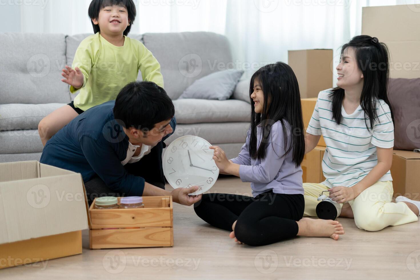 Moving house. relocation. Family smile and play together after move to new home, inside the room was a cardboard box contain personal belongings and furniture. move in the new apartment, condominium photo