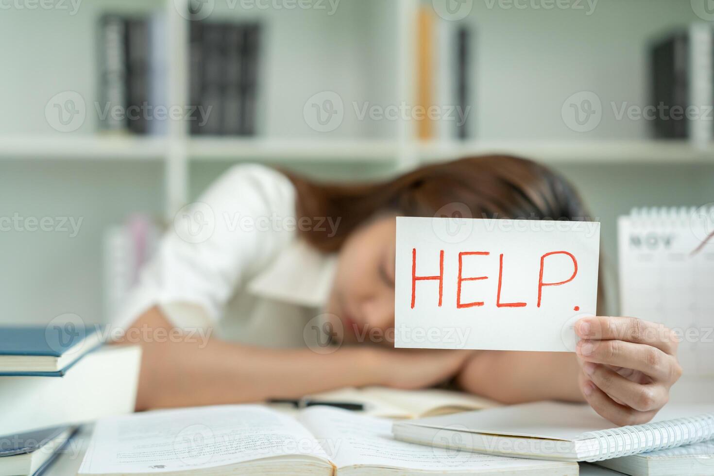 student woman have anxiety because of exams, female hold help in the library. stress, despair, haste, misunderstanding reading, discouraged, expectation, knowledge photo