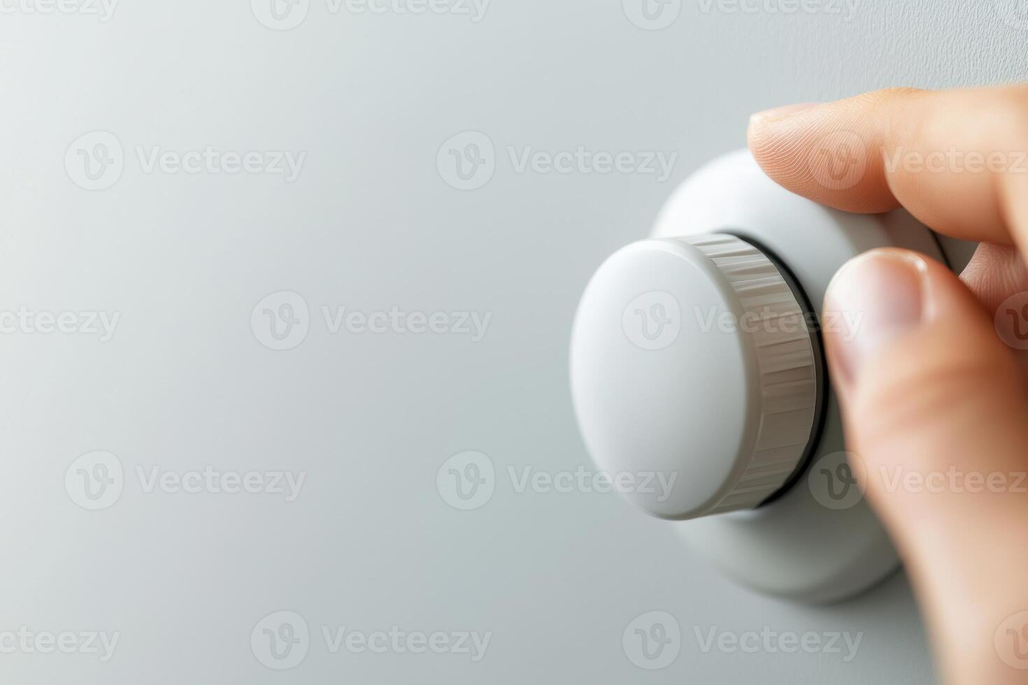 Person Adjusts Radiator Thermostat in a Home Setting for Optimal Comfort photo