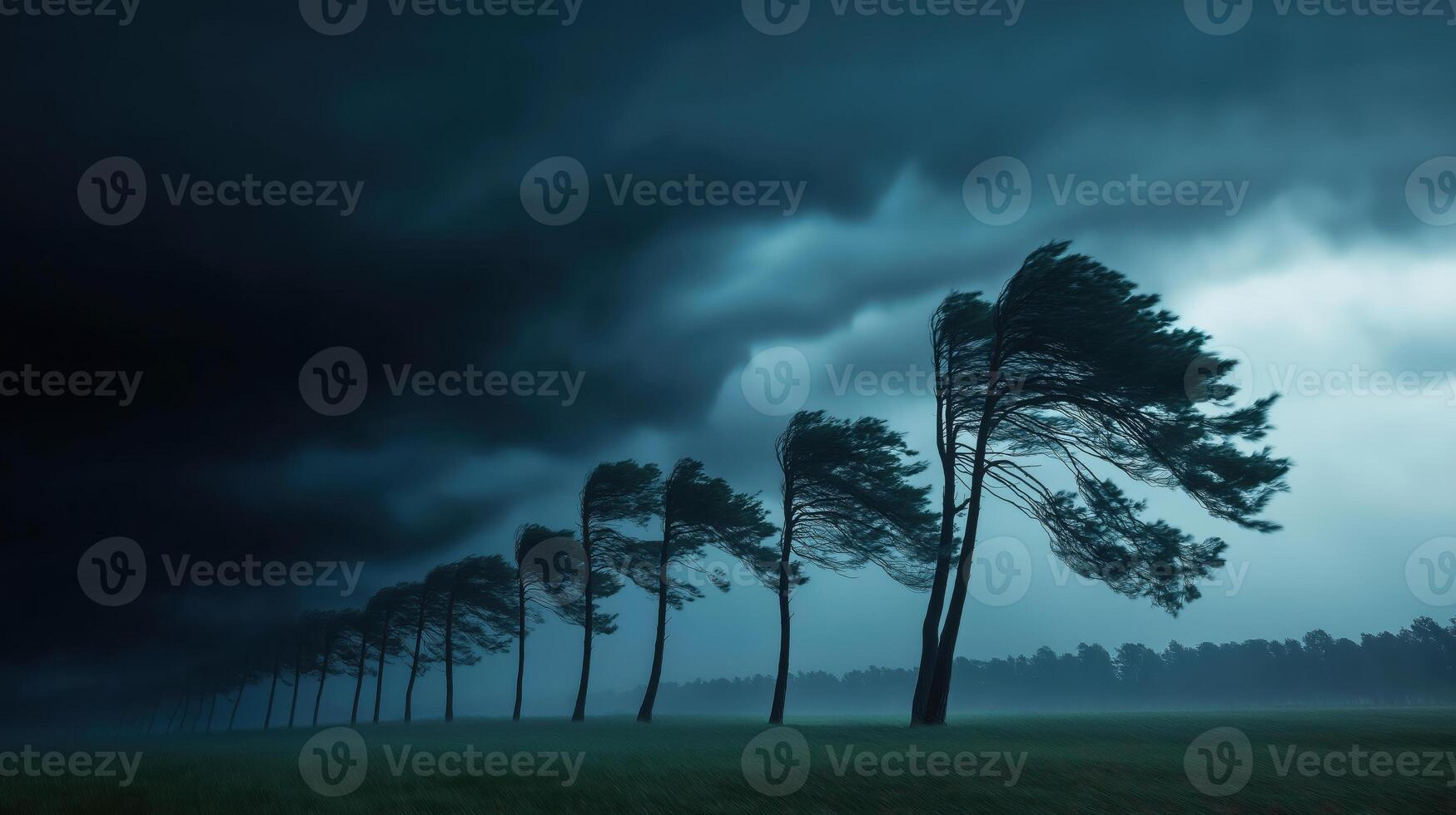 Stormy Atmosphere with Windswept Trees Under Dark Skies and Dramatic Clouds photo