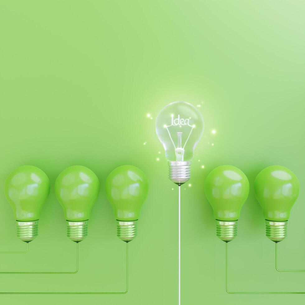 Energy saving light bulb on green Background with idea concept. photo