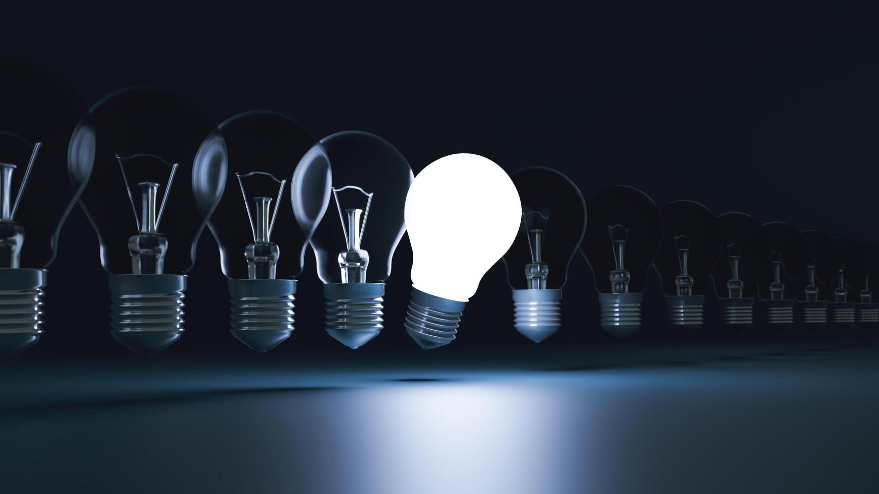 Idea concept and light bulb that illuminate on blue background. photo