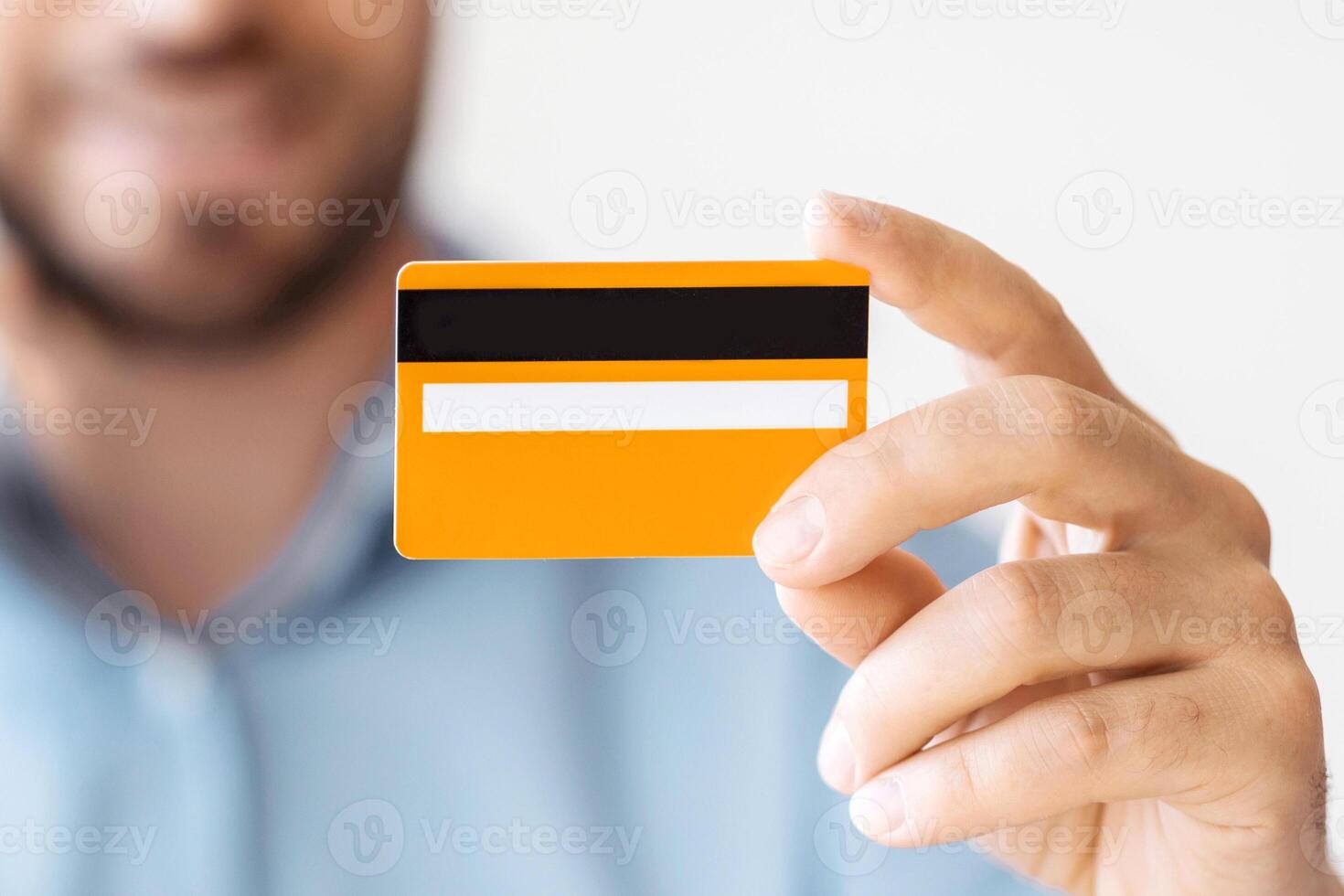 Online Banking. Unrecognizable Man Holding Credit Card And Talking On Cellphone, Paying In Internet, Closeup Shot With Selective Focus, photo