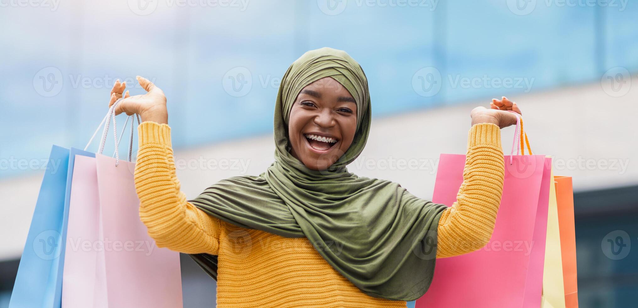 Sale Season. Joyful Black Muslim Woman In Headscarf Posing Outdoors With Lots Of Shopping Bags, Euphoric African Islamic Lady In Headscarf Carrying Purchases And Smiling At Camera, Free Space photo