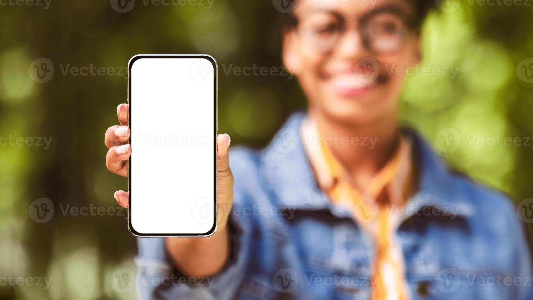 Unrecognizable Black Woman Showing Cellphone Empty Screen Recommending Application Standing Outdside. Shallow Depth, Mockup, Panorama photo