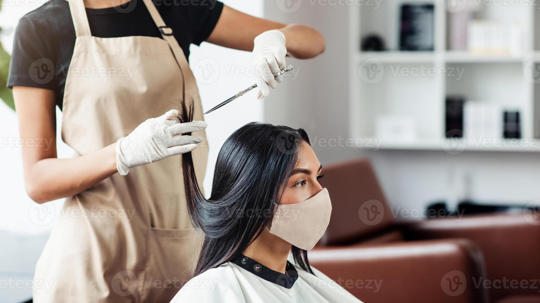 Working with safety. Hairdresser and customer in salon with medical masks during virus pandemic, empty space photo
