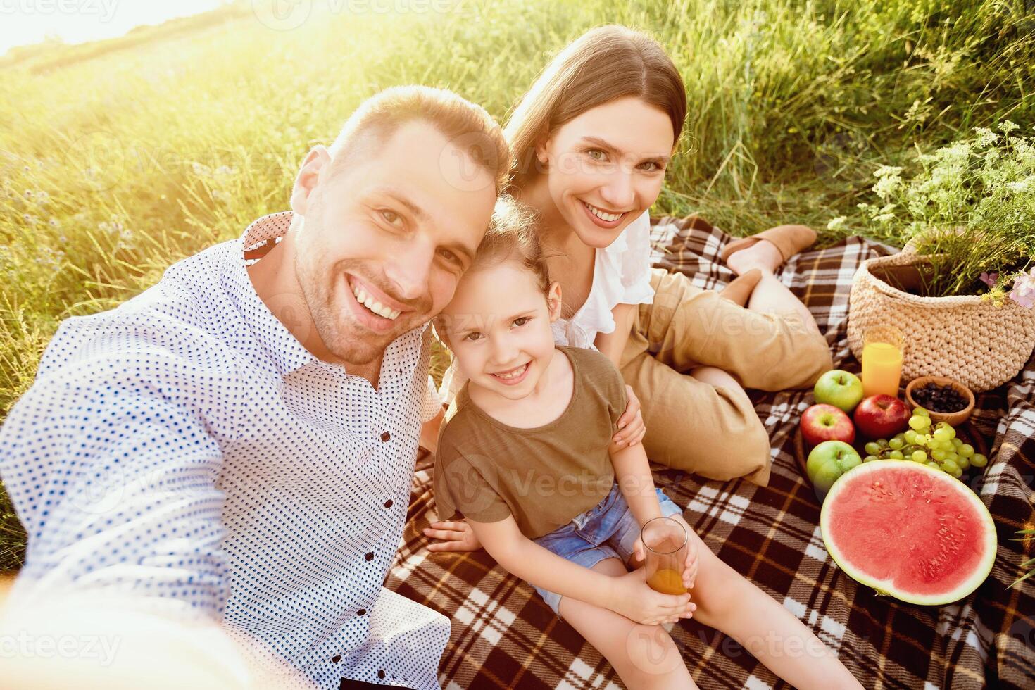 Selfie Time. Lovely family having picnic in nature and making photo together, smiling at camera