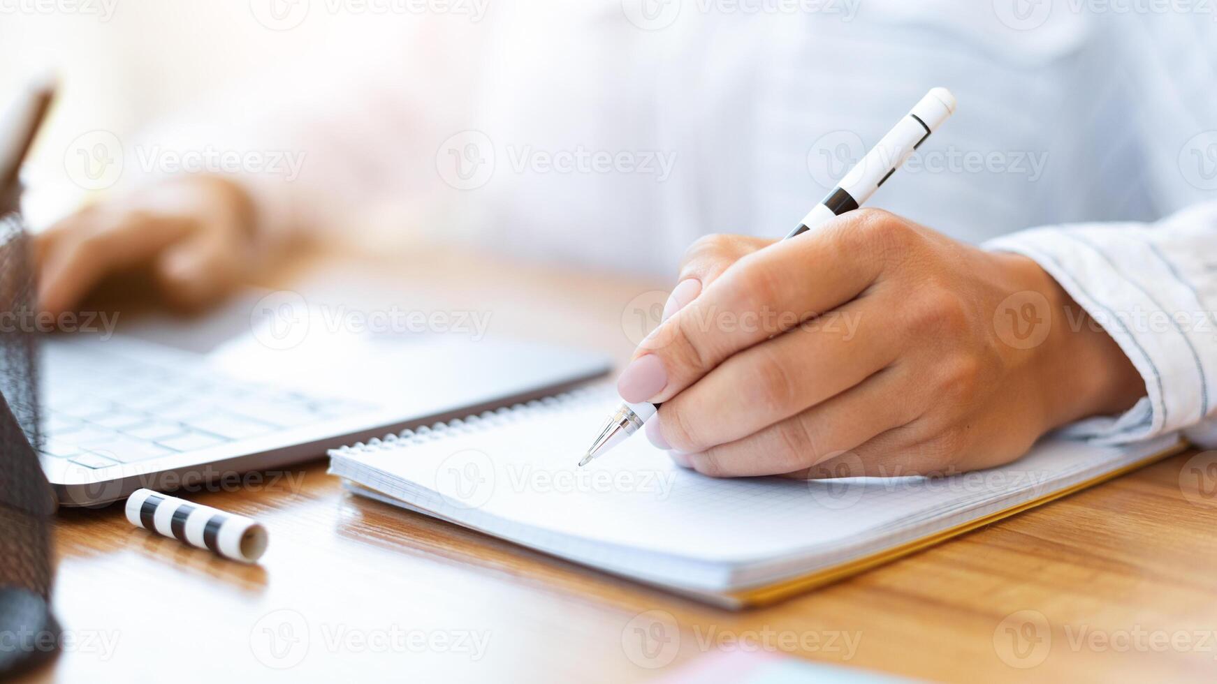 Personal Planner. Unrecognizable person writing in notebook sitting at working place, making notes, planning schedule photo