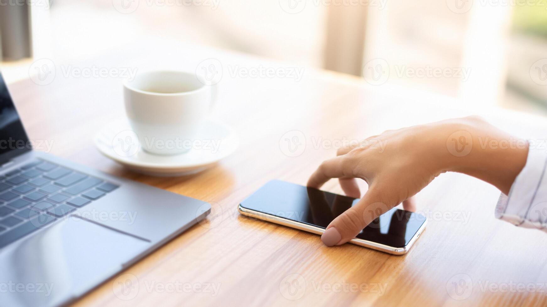 Time For Break. Unrecognizable woman picking up her smart phone from wooden desk at work photo