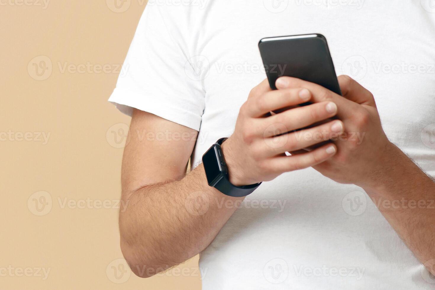 Modern online communication, unrecognizable man using phone, copy space, cropped, beige studio background photo