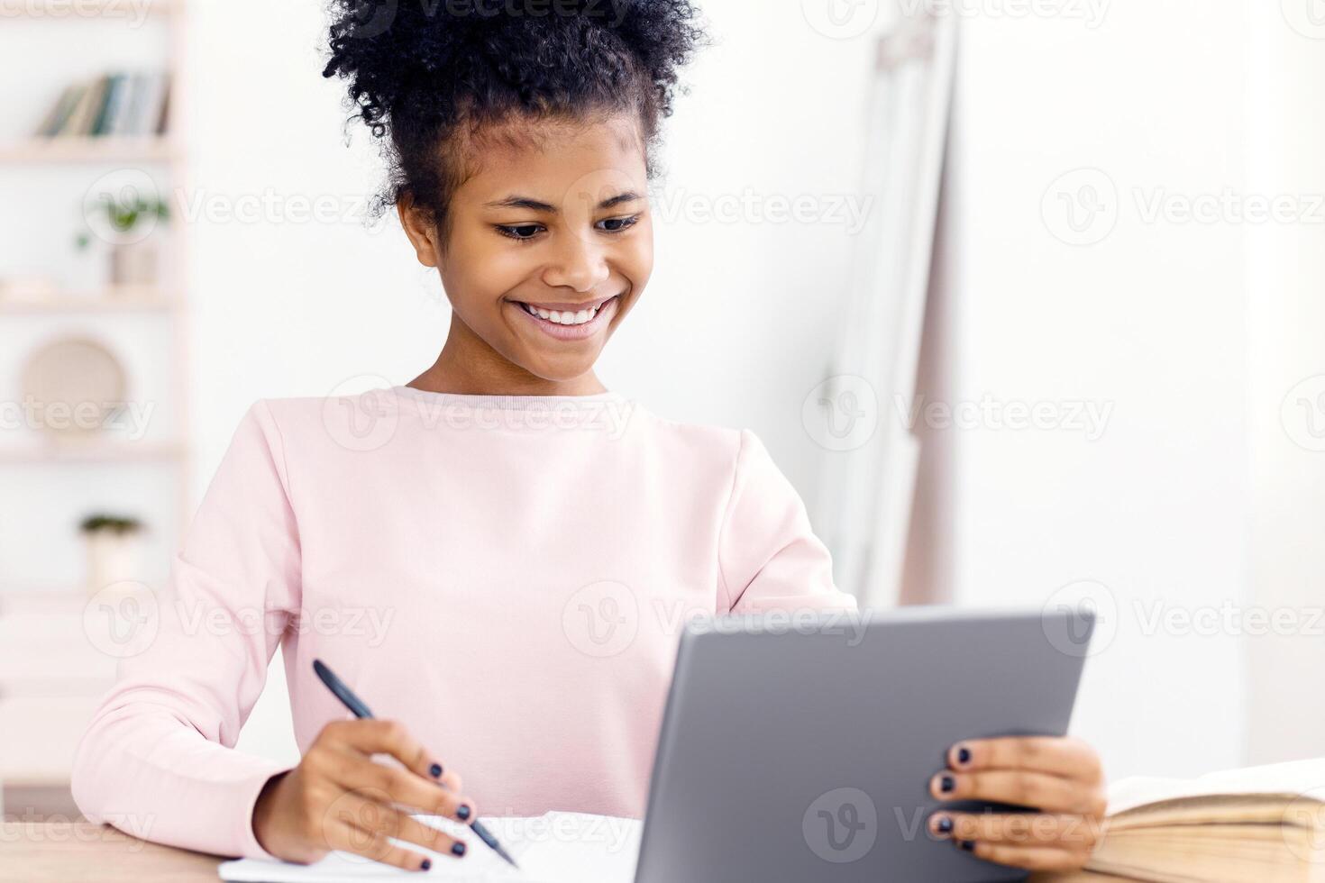 Online Learning. Cheerful Black Secondary School Student Girl Studying Using Digital Tablet At Home. Selective Focus photo