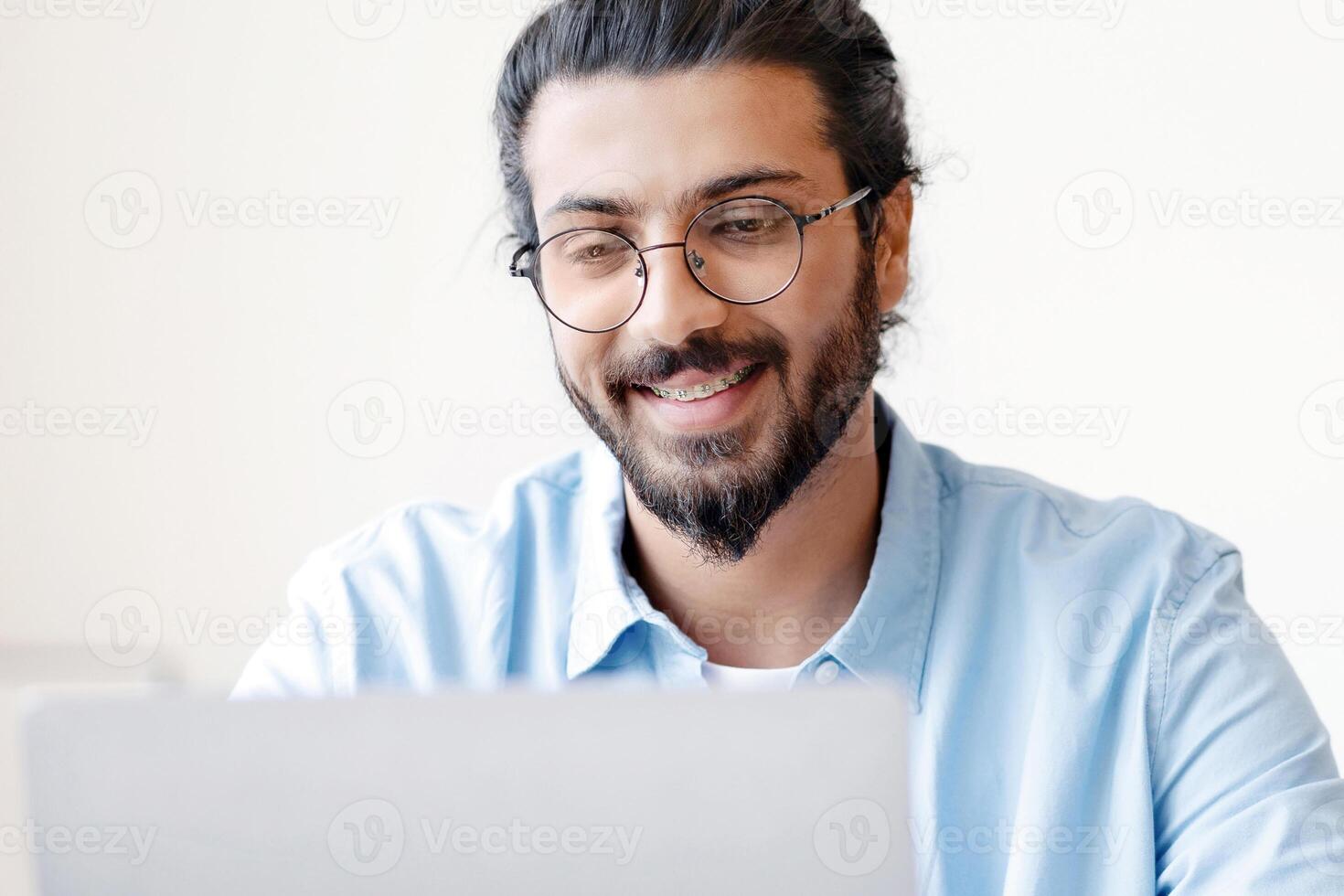 Recruitment Concept. Smiling Eastern Guy Using Laptop, Searching Job Online, Browsing Websites In Internet, Looking For Work Opportunities, Positive Arab Man Sitting At Desk At Home, Copy Space photo