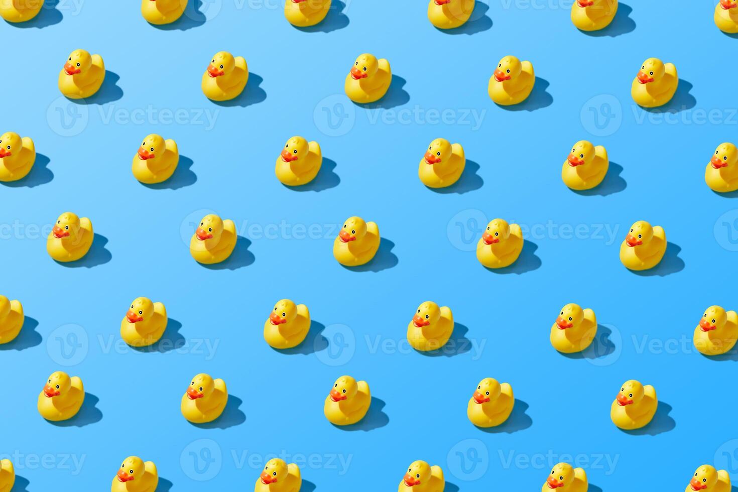 Colorful Pattern of Rubber Duckies on Blue Background photo