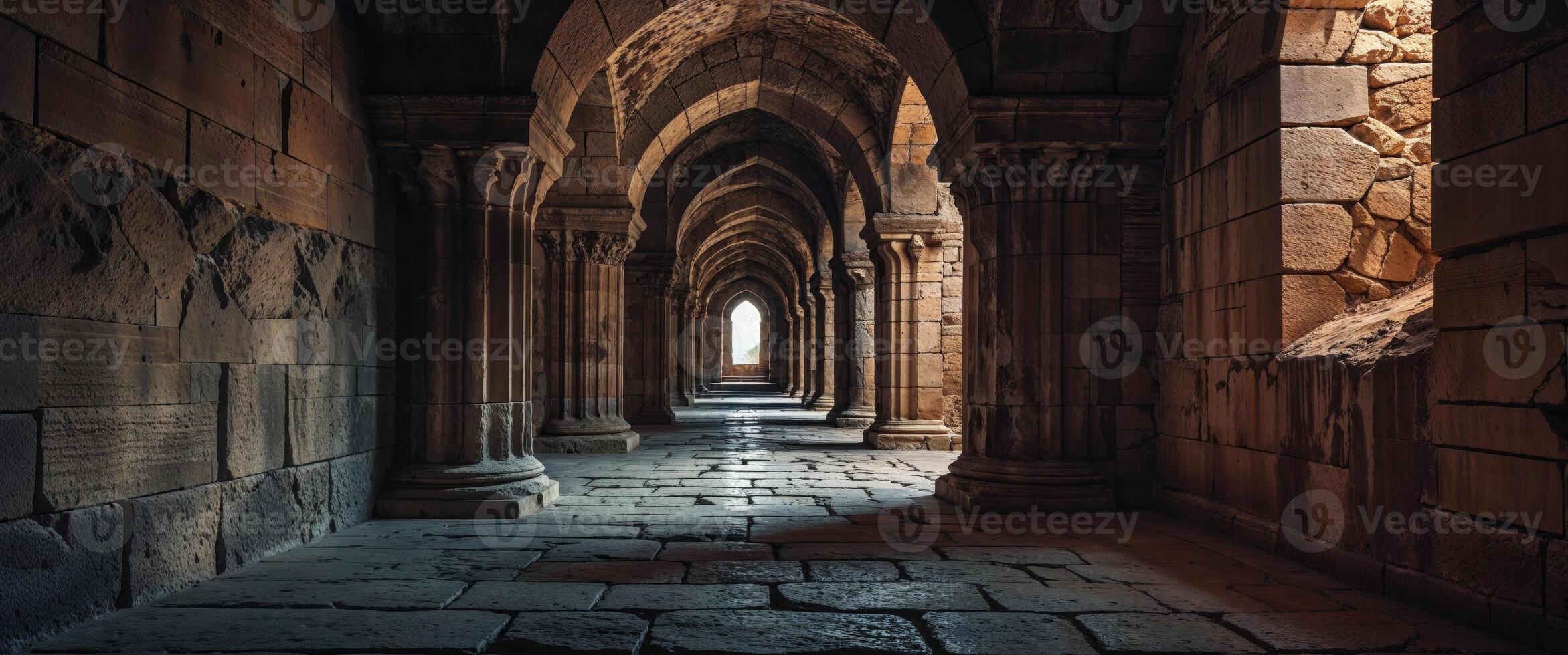 A long hallway with stone pillars and arches photo
