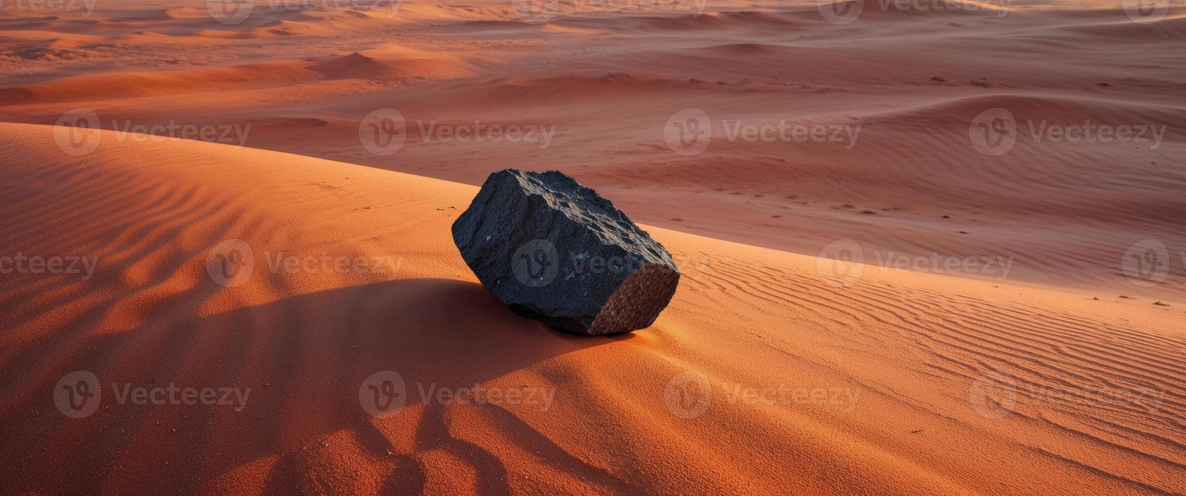A rock sits in the middle of a desert photo
