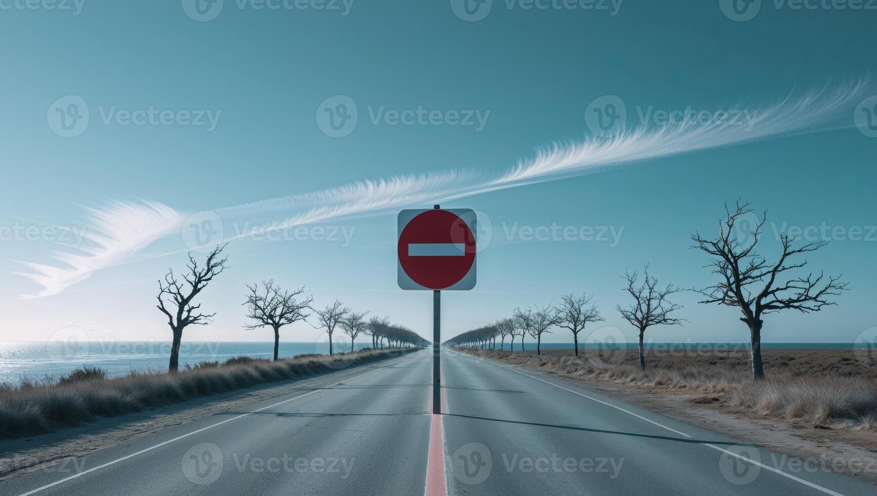 Serene Coastal Road with No Entry Sign Under Clear Blue Sky. photo