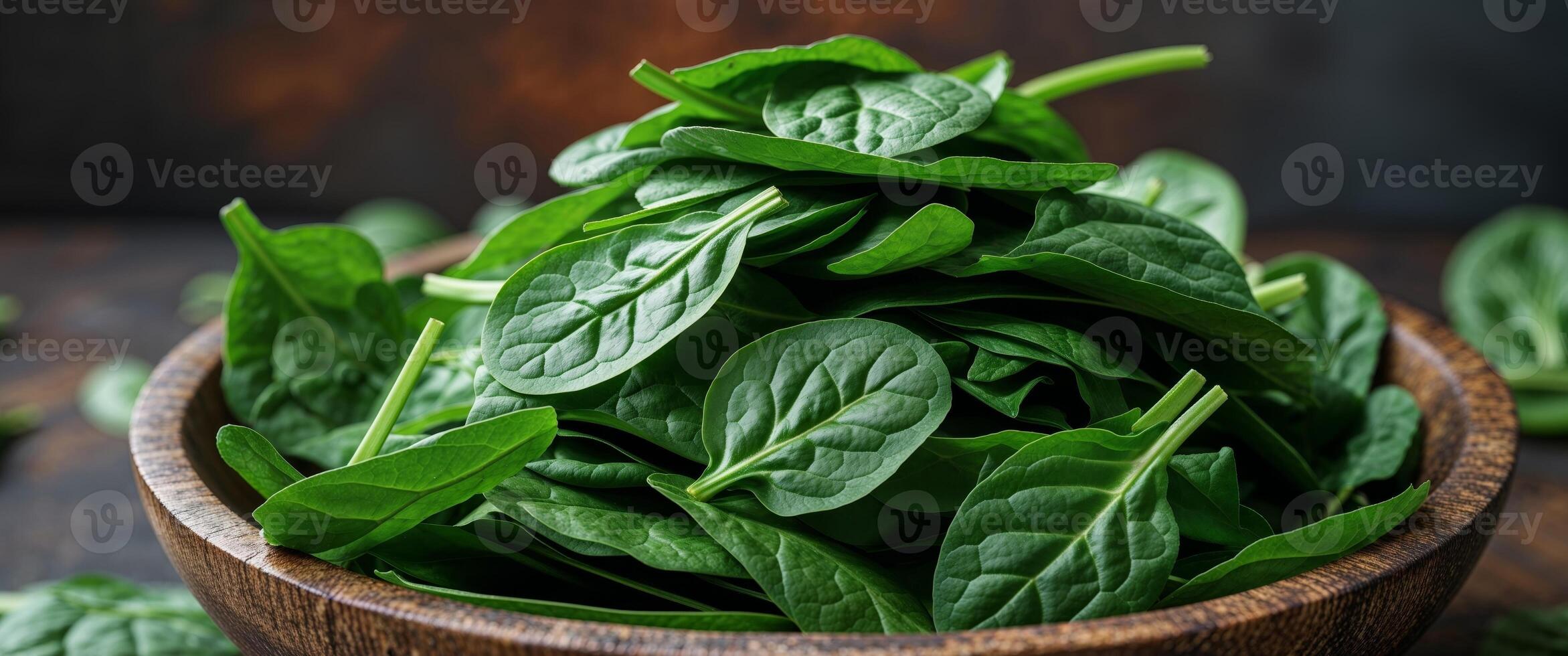 Fresh spinach squares in wooden bowl on dark background. photo