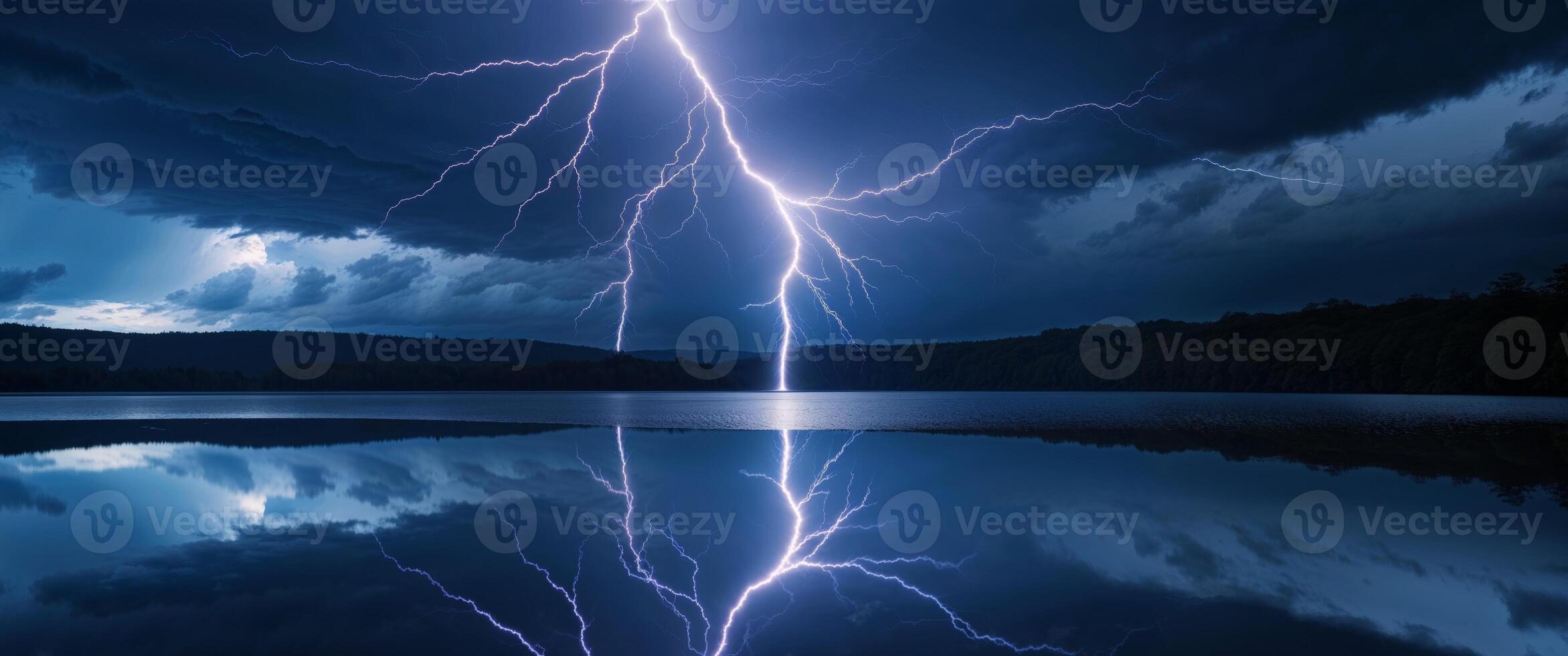 Intense Lightning Strike Illuminated Over Dark Lake during Nighttime Storm with Illuminated Reflection photo