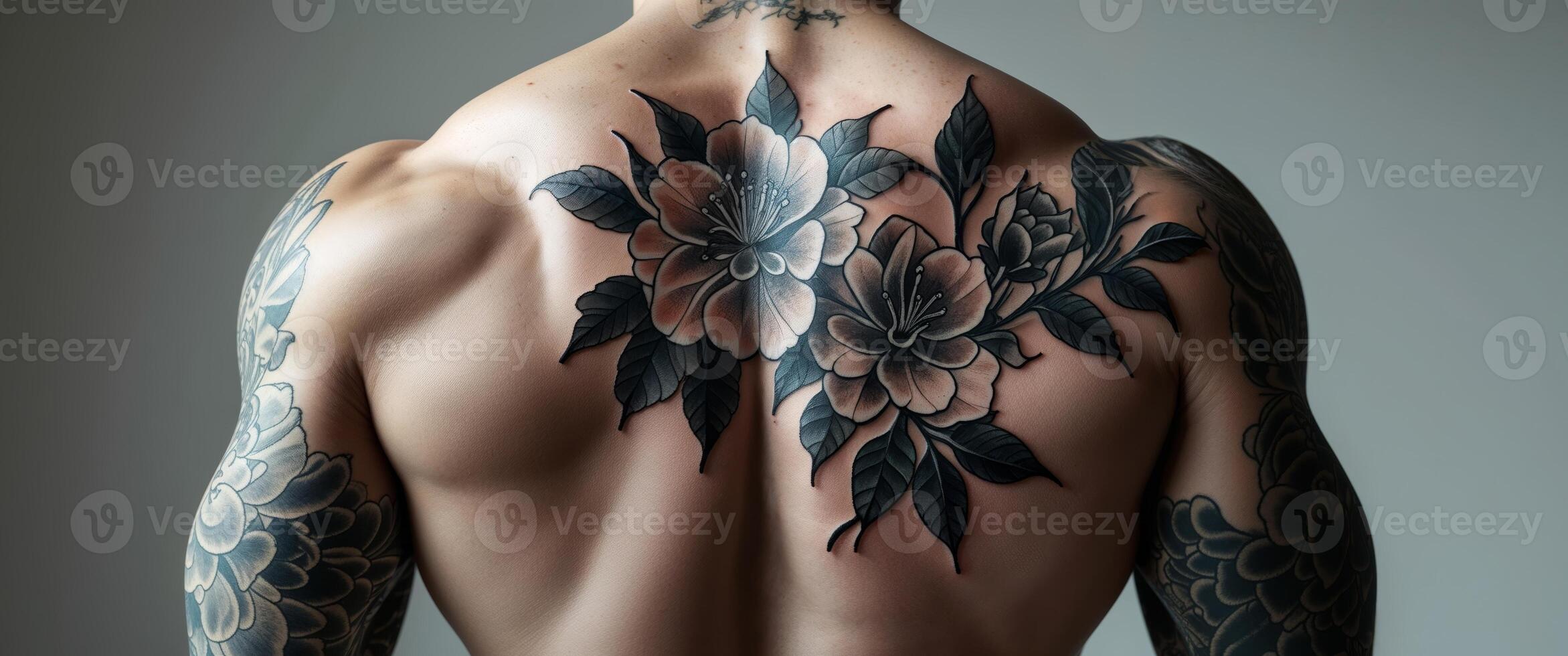 Torso View of Tatted Man's Back with Black Floral Design Artwork. photo