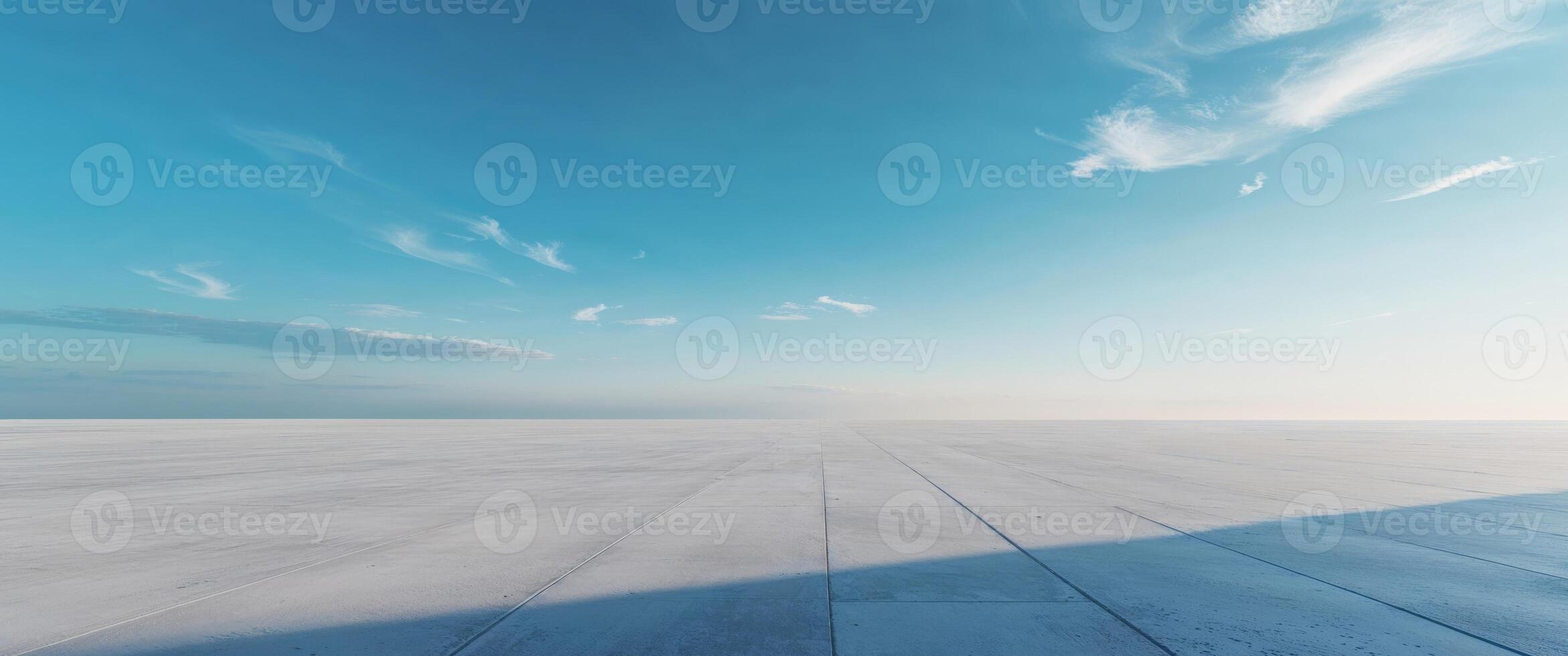 Dramatic scene with light highlighting a smooth concrete floor and sky photo