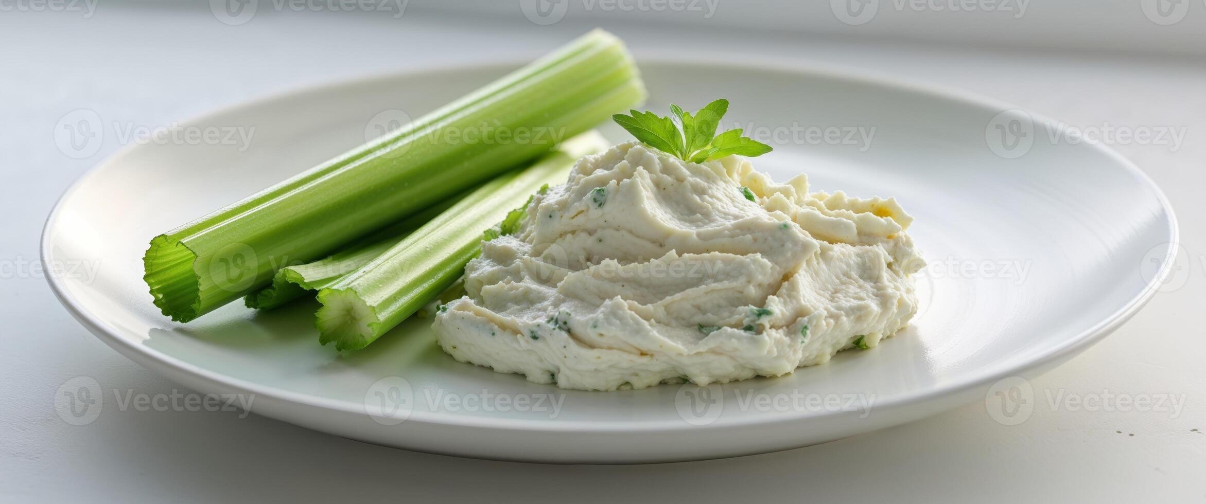 A plate with celery and a bowl of cream cheese photo