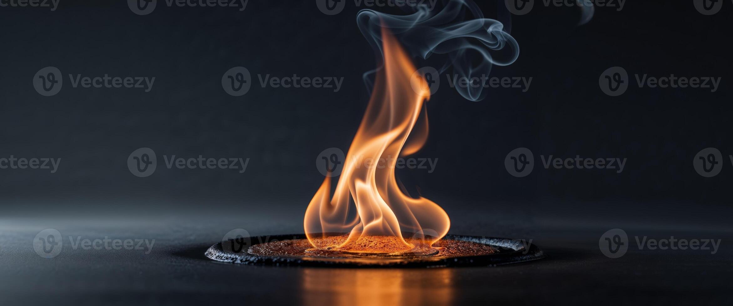 A somber reflective flame burning with a subtle glow that mourns photo
