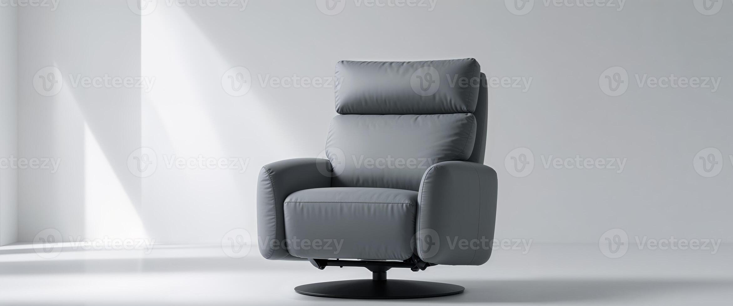 A gray recliner chair in a room with white walls photo
