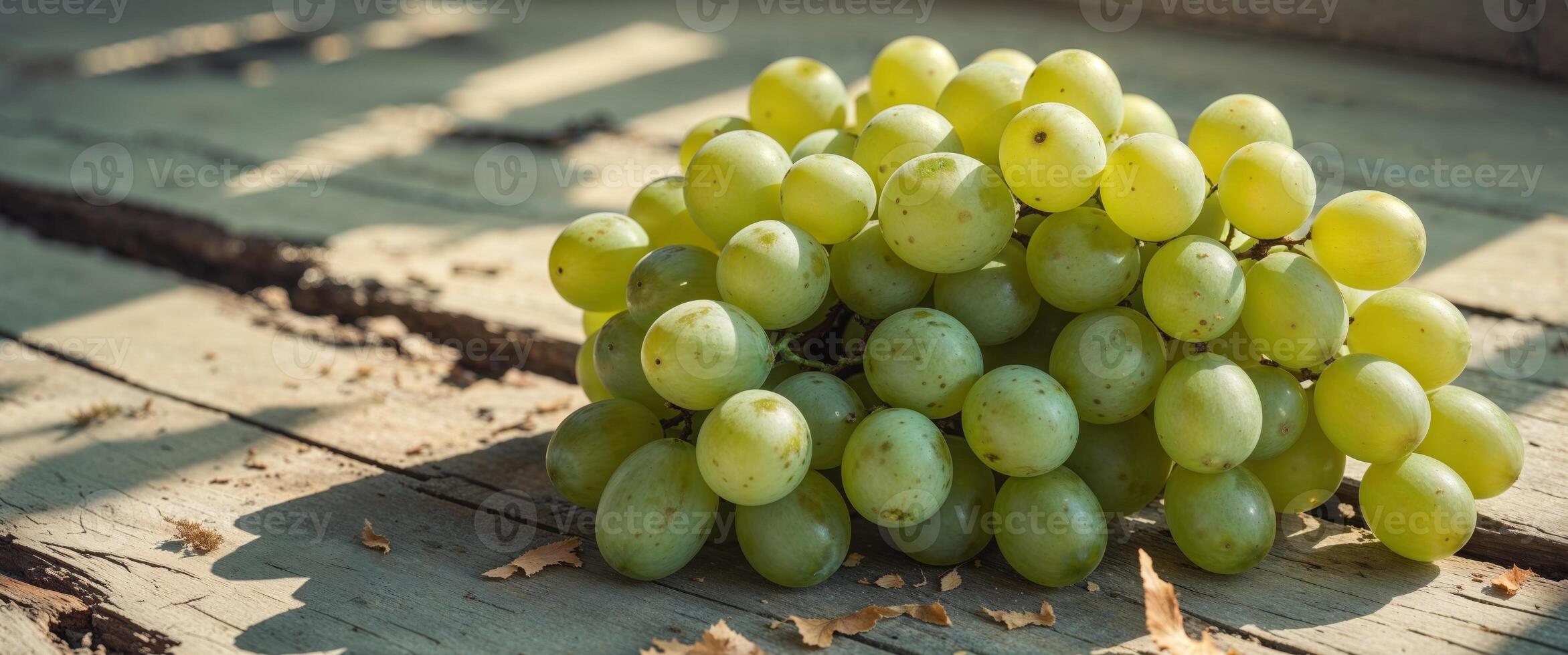 A bunch of green grapes sitting on a wooden table photo