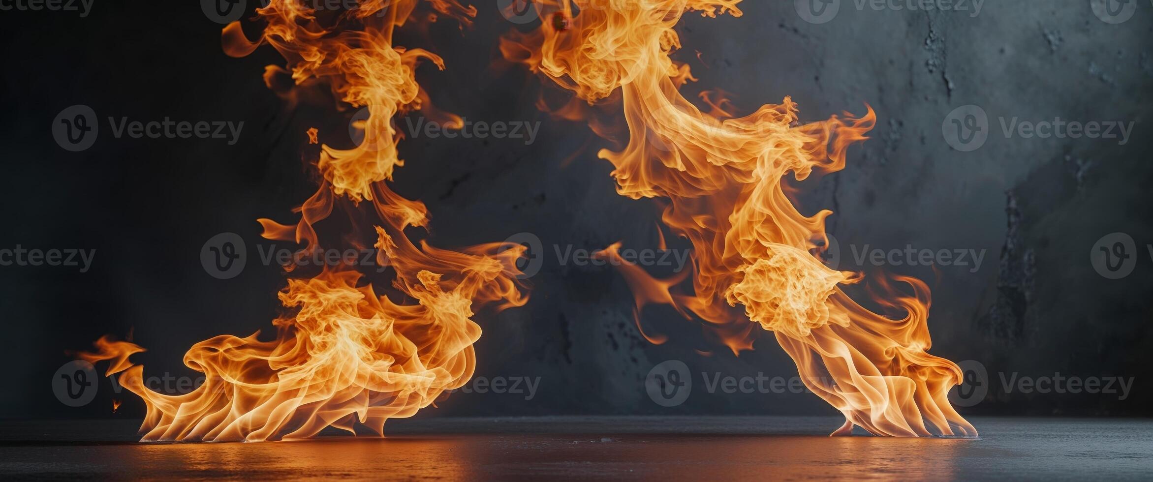 Orange and Yellow Flames Burning on Dark Surface. photo