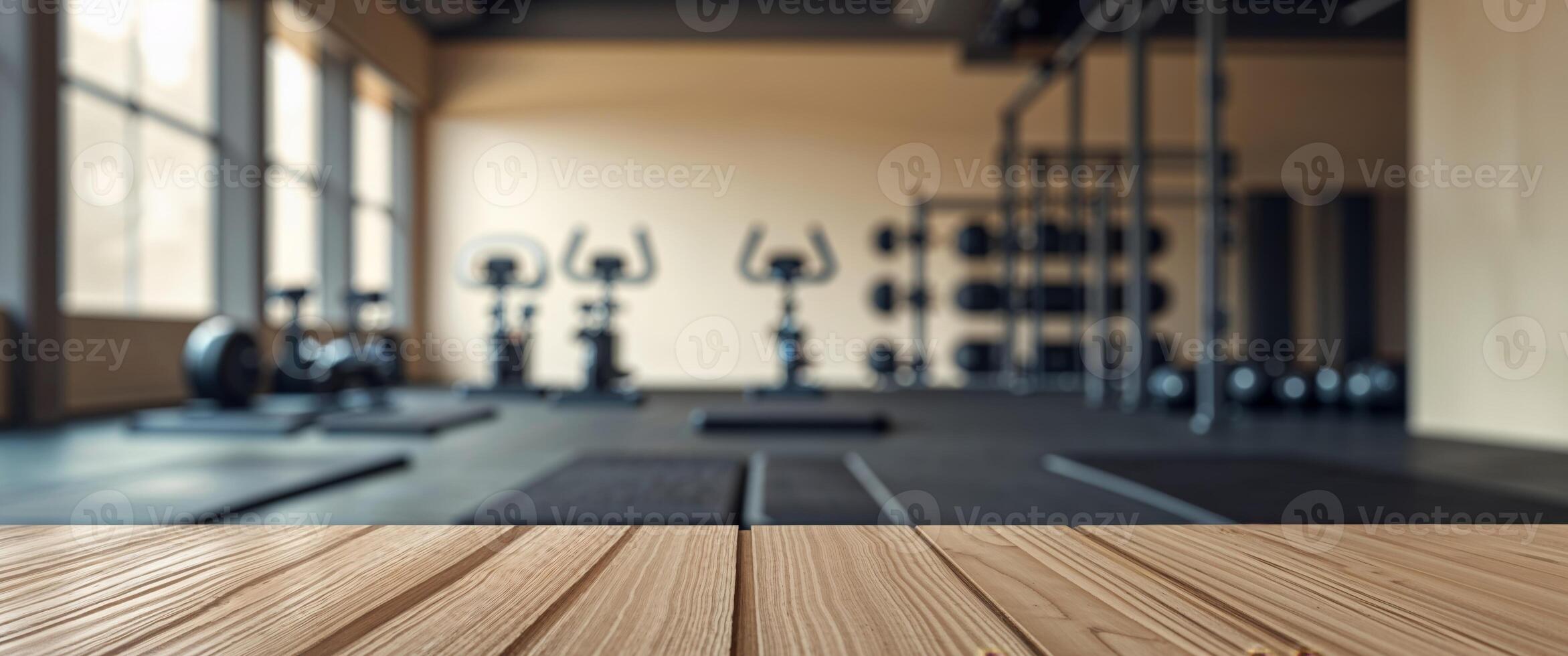 Wooden table in gym room with exercise equipment photo
