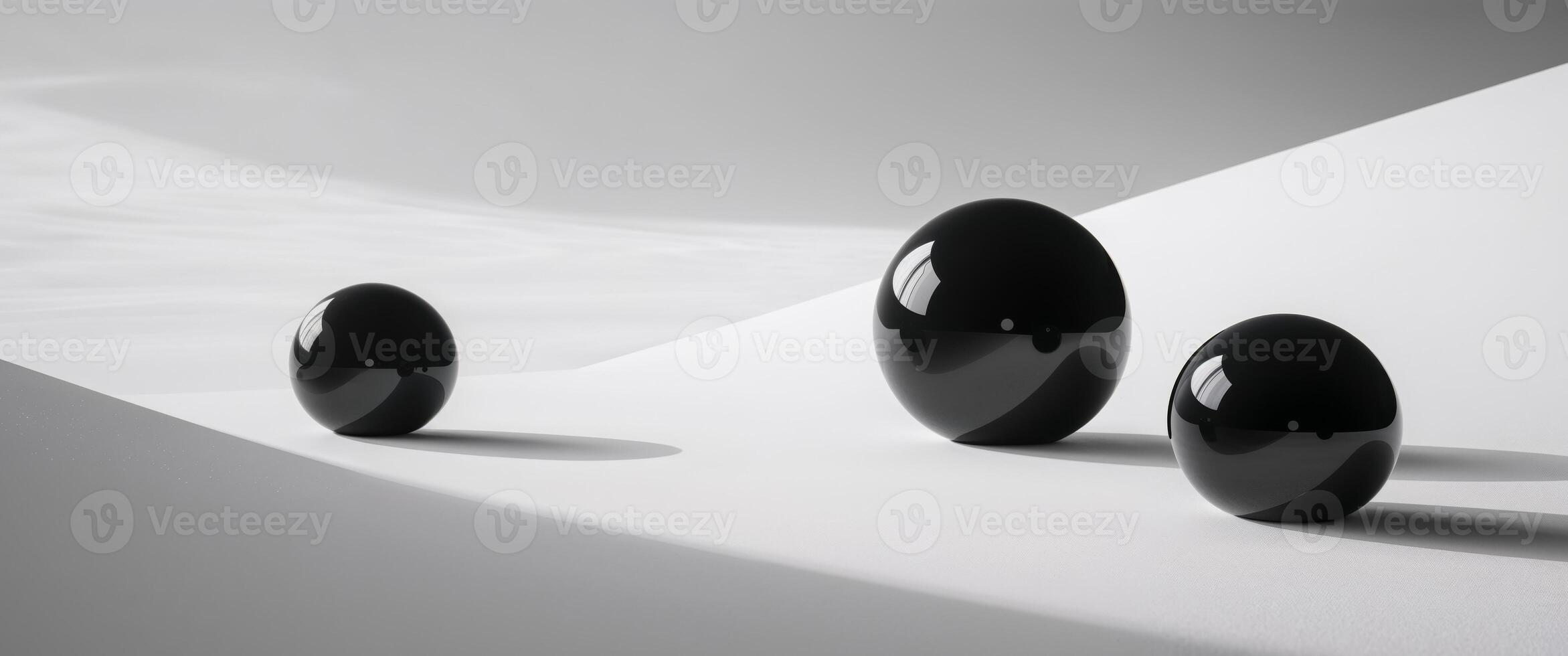 Three black round objects are on a white surface photo
