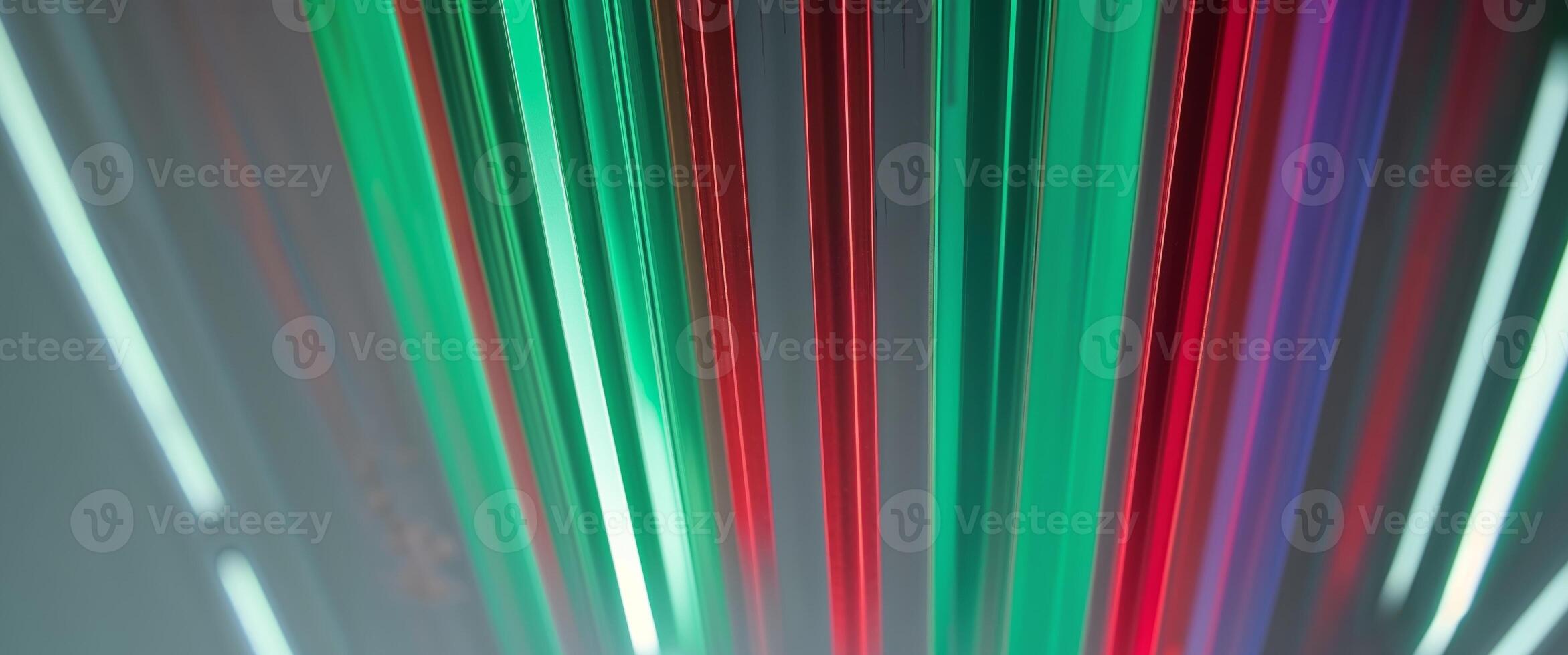 Glowing vertical bars in shades of green and red with reflections on a shiny surface below them photo