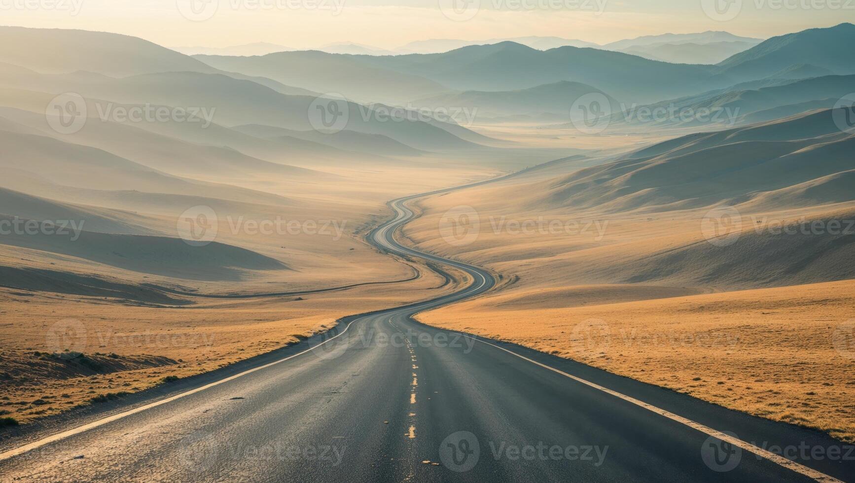 a view of a valley with a winding road in the middle of it photo
