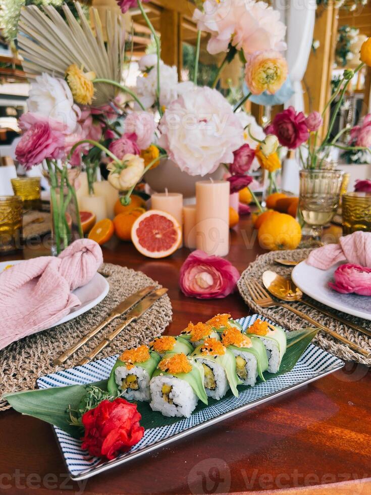 An Elegant Presentation of Sushi with Lovely Floral Accents photo