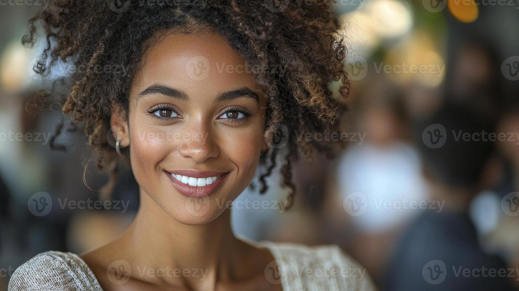 A beautiful young woman with curly hair smiling photo