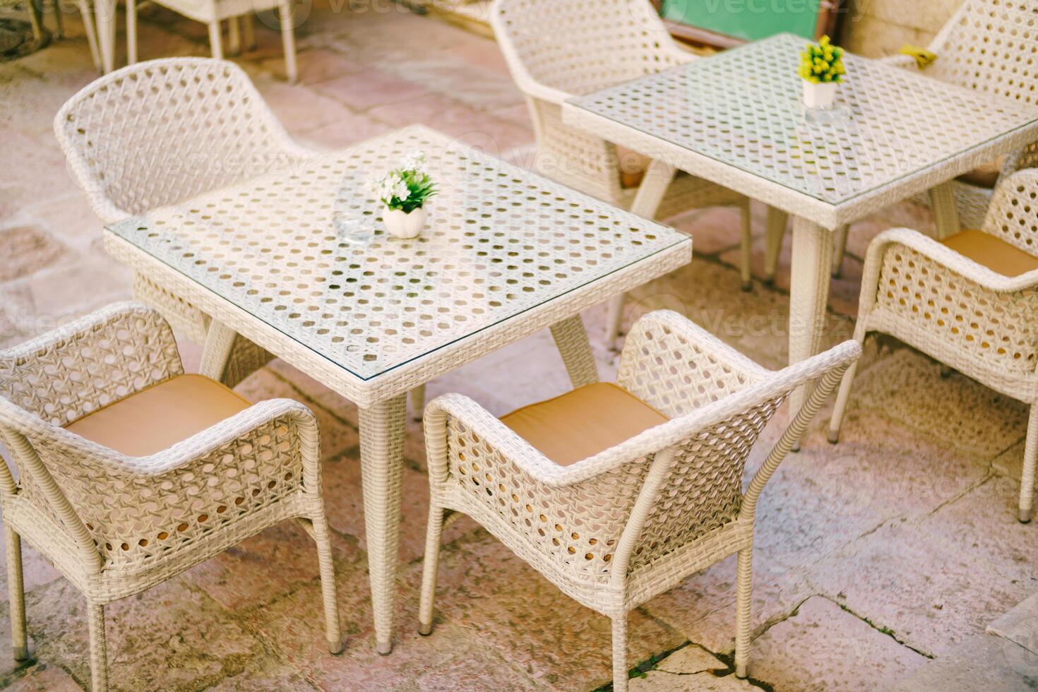 Outdoor Dining Set with White Rattan Chairs and Tables photo